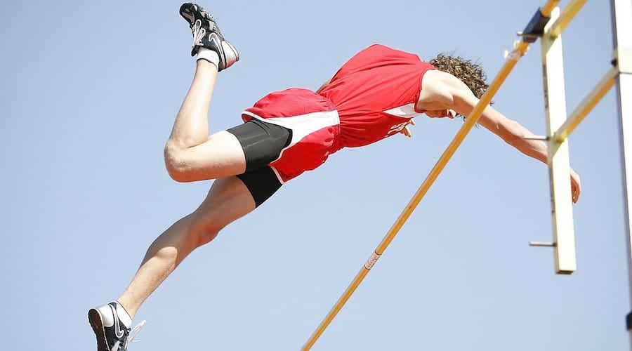 A pole vaulter crossing the bar