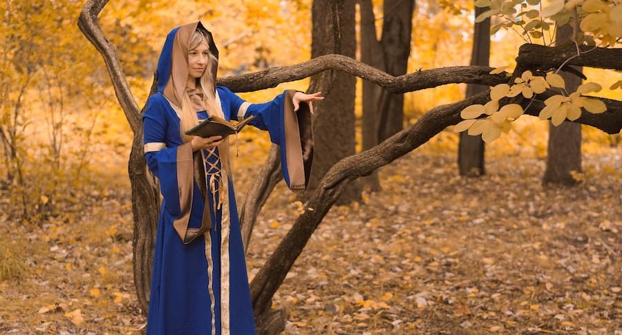 A fair witch doing magic in a forest